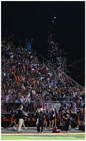 A football player catching a ball. Description generated by AI