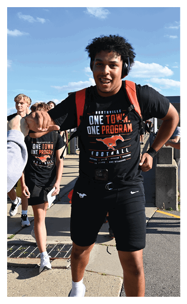 A young man wearing a football jersey with the name Vista on the back. AI generated content