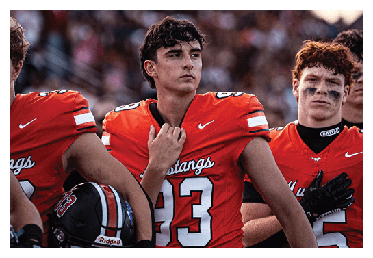 A group of football players wearing headphones and smiling. AI generated content