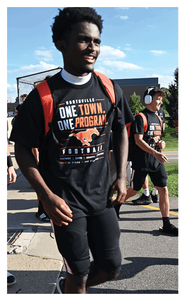 A young man wearing a football jersey with the name Vista on the back. AI generated content