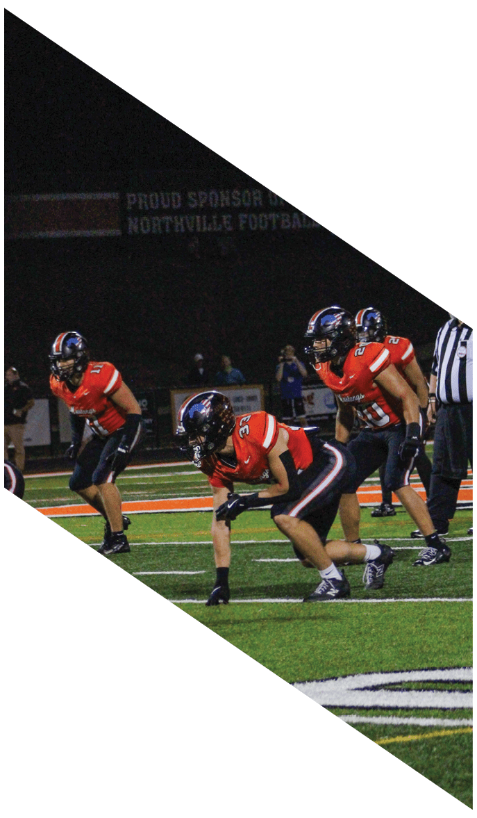 A group of people wearing black jerseys are huddled together on a field. AI generated content