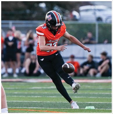 A football player running on the field. Description generated by AI
