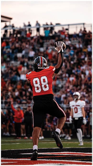 A football player wearing a blue jersey with the number 58 on it. Description generated by AI