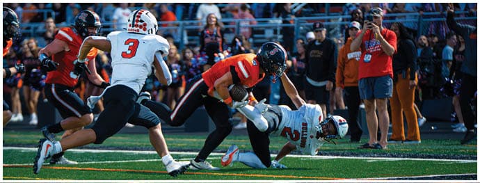 A football player is sliding on the ground. Description generated by AI