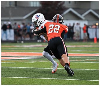 A group of football players wearing black and white uniforms. Description generated by AI