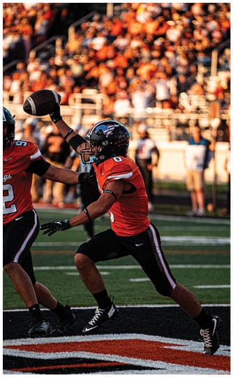 A football player is sliding on the ground. Description generated by AI