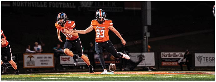 A football player is sliding on the ground. Description generated by AI