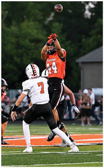 A football player is sliding on the ground. Description generated by AI