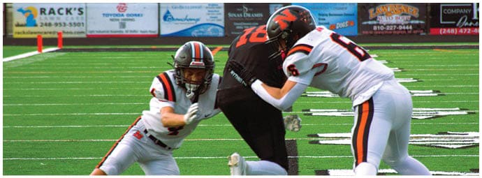 A football player wearing a blue and white uniform. Description generated by AI