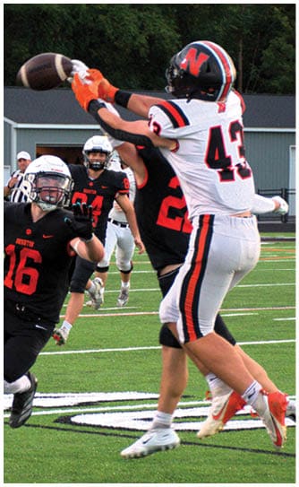 A football player catching a ball. Description generated by AI