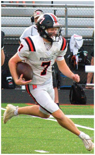 A football player catching a ball. Description generated by AI