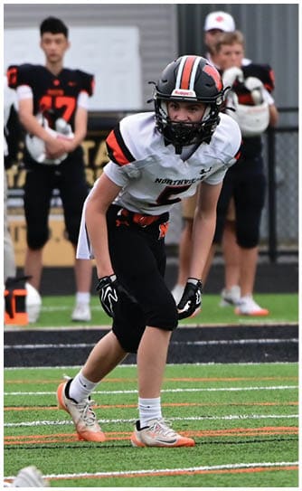 A football player catching a ball. Description generated by AI