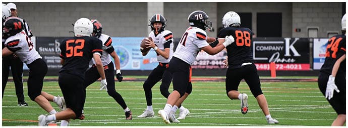 A football player wearing a blue and white uniform. Description generated by AI
