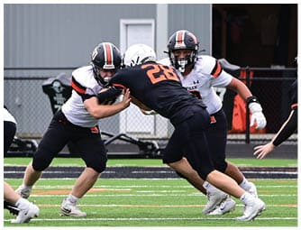 A group of football players on a field. Description generated by AI