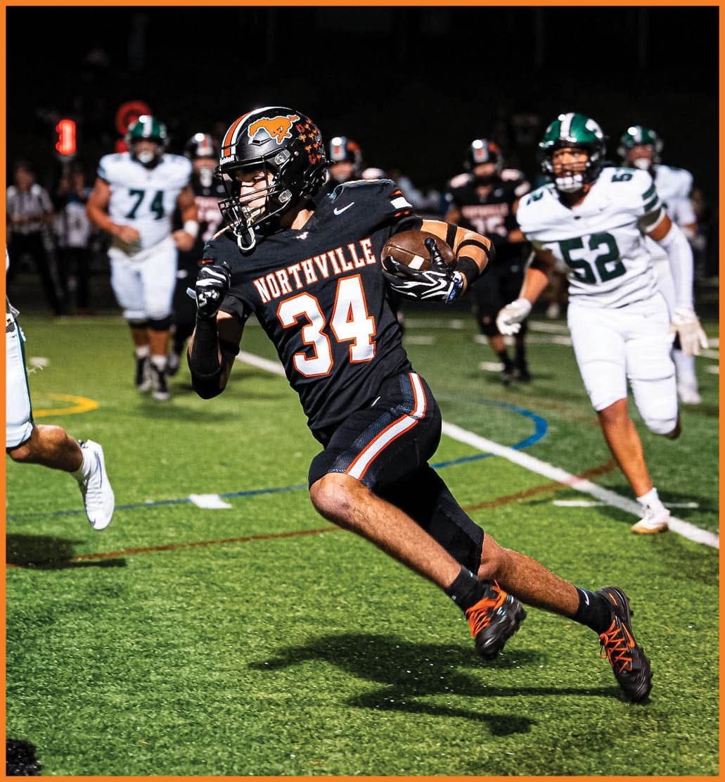A football player running on the field. Description generated by AI