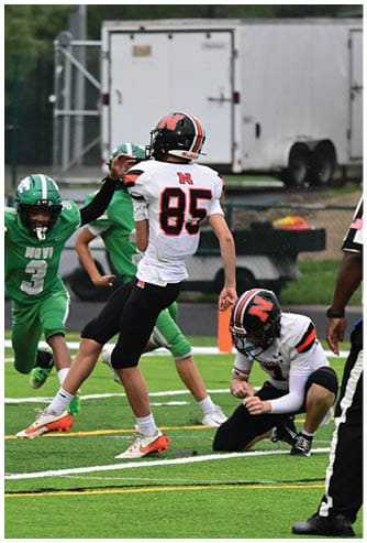 A football game is being played on a field. Description generated by AI