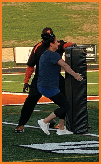 A football player catching a ball. Description generated by AI
