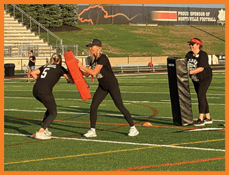 A group of football players on a field. Description generated by AI