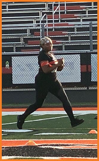 A football player catching a ball. Description generated by AI