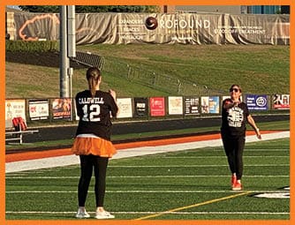 A group of football players on a field. Description generated by AI