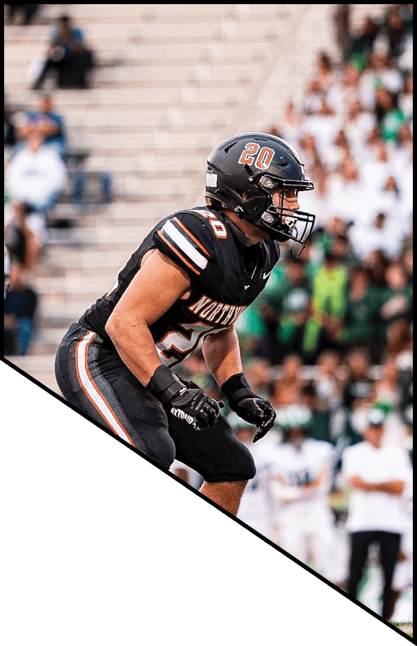 A football player is kneeling on the field, holding his helmet in his hands. AI generated content