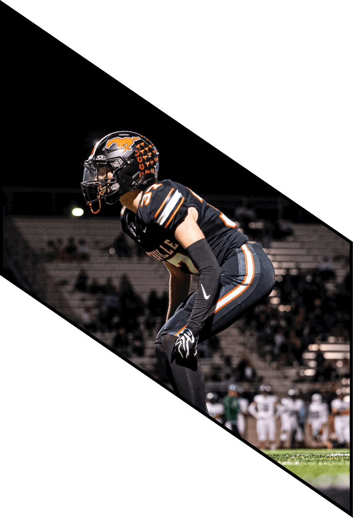 Four football players pose for a picture on the field. AI generated content