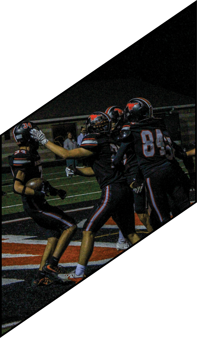 A group of people wearing black jerseys are huddled together on a field. AI generated content