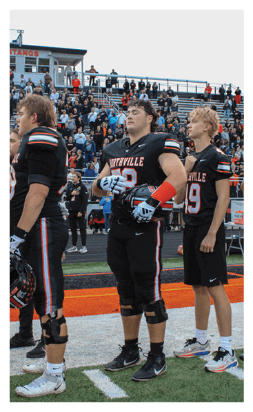 A young man wearing a football jersey with the name Vista on the back. AI generated content