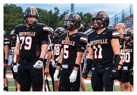 A group of football players wearing headphones and smiling. AI generated content