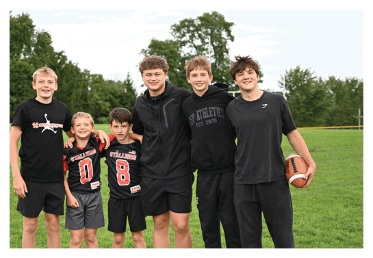 A group of people are kneeling on a field, possibly in a football game. AI generated content