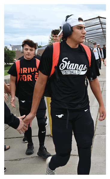 A young man wearing a football jersey with the name Vista on the back. AI generated content