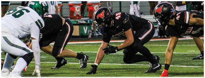 A football player is sliding on the ground. Description generated by AI