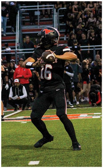 A football player is sliding on the ground. Description generated by AI