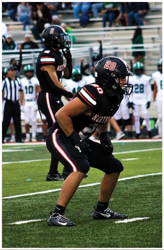 A football player running on the field. Description generated by AI