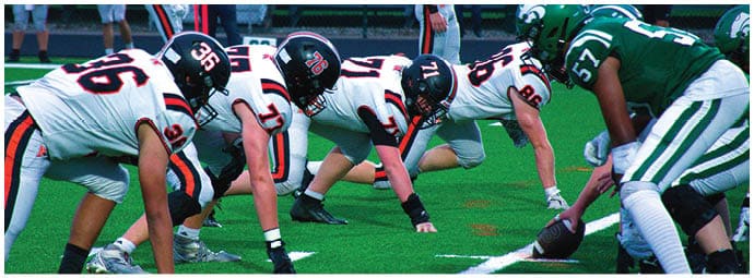 A football player wearing a blue and white uniform. Description generated by AI