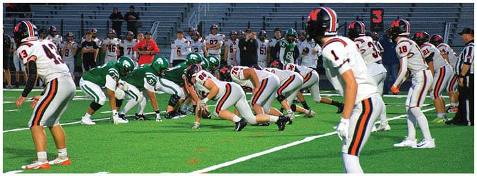 A football player wearing a blue and white uniform. Description generated by AI