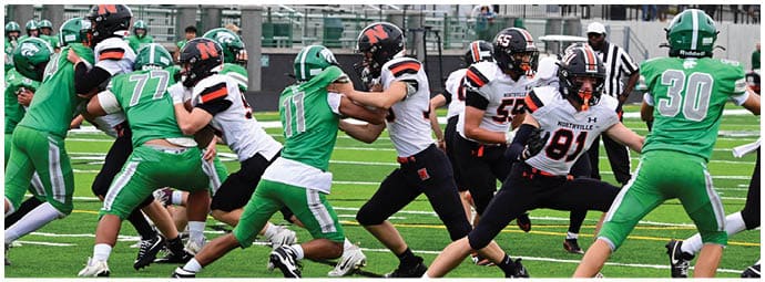 A football player wearing a blue and white uniform. Description generated by AI