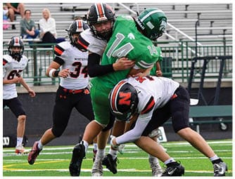 A group of football players on a field. Description generated by AI