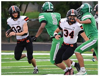 A group of football players on a field. Description generated by AI