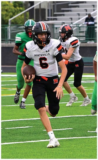 A football player catching a ball. Description generated by AI