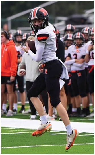 A football player catching a ball. Description generated by AI