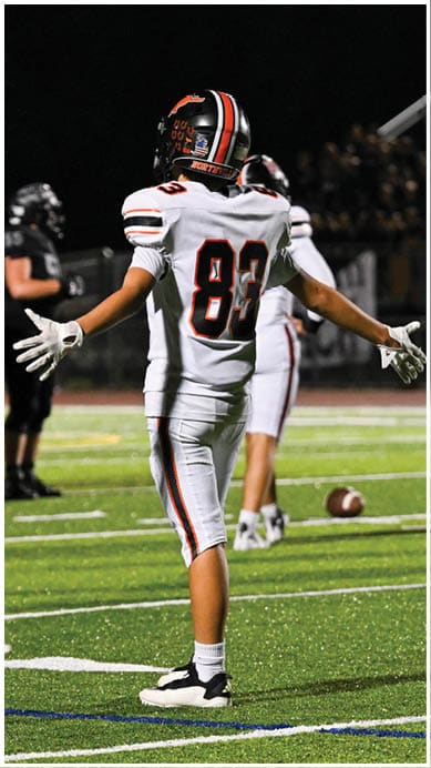 A football player wearing a blue jersey with the number 58 on it. Description generated by AI