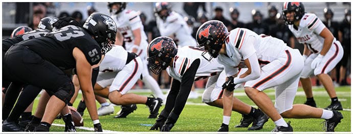 A football player is sliding on the ground. Description generated by AI