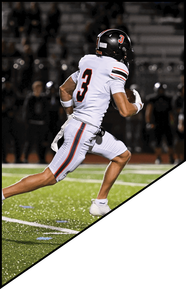 A football player is kneeling on the field, holding his helmet in his hands. AI generated content