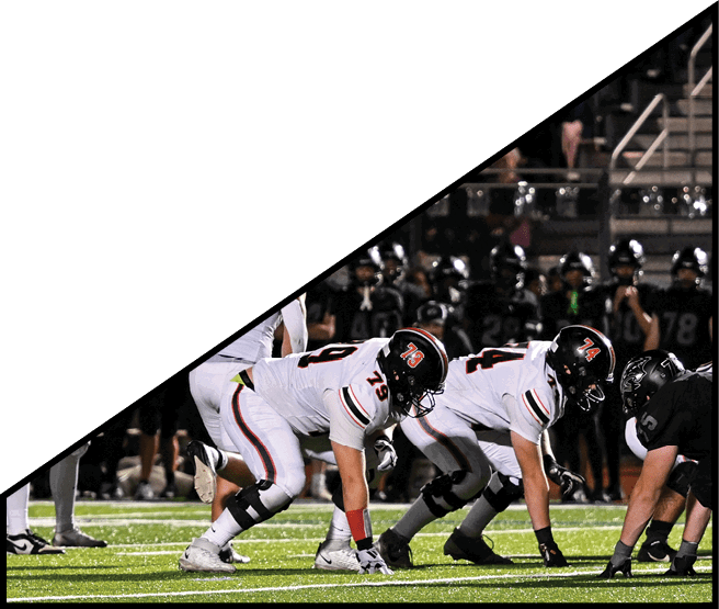 A group of football players kneeling on the field, some with their hands on their heads. AI generated content