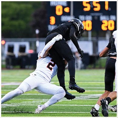 A football player running on the field. Description generated by AI