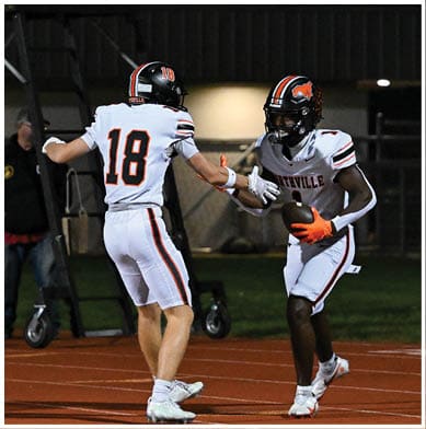 A football player running on the field. Description generated by AI