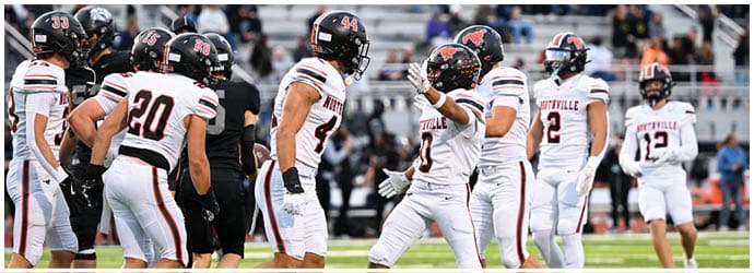 A group of football players on a field. Description generated by AI