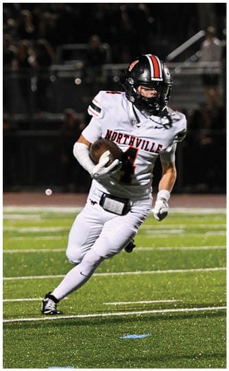A football player is sliding on the ground. Description generated by AI