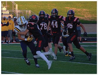 A group of football players on a field. Description generated by AI